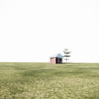 a small house in the middle of a field